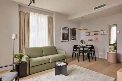 a living room with a couch and a table at Wilde Aparthotels Amsterdam Noord in Amsterdam