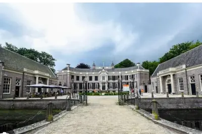 a large building with a walkway in front of it at Weidezicht Soest, beauty & wellness en rust & natuur in Soest