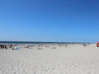 a large group of people on a beach at One-bedroom apartment in Heemskerk