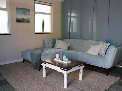 a living room with a couch and a coffee table at One-bedroom apartment in Heemskerk