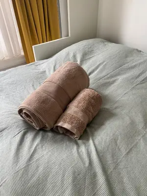 two brown pillows sitting on top of a bed at Cozy Room in Oldwest with private bathroom in Amsterdam
