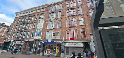 a building on a street with people walking in front of it at Cozy Room in Oldwest with private bathroom in Amsterdam