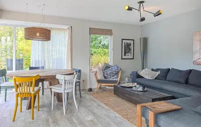 a living room with a couch and a table and chairs at 2 Bedroom Beautiful Home In Noordwijkerhout in Noordwijkerhout