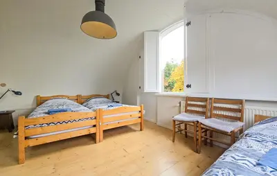 a bedroom with two twin beds and a window at 2 Bedroom Beautiful Home In Noordwijkerhout in Noordwijkerhout