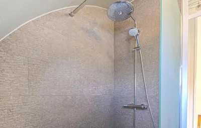 a shower with a shower head in a bathroom at 2 Bedroom Beautiful Home In Noordwijkerhout in Noordwijkerhout