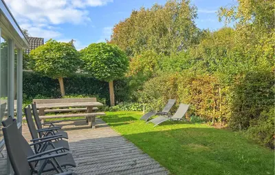 a group of park benches sitting on a deck at 2 Bedroom Beautiful Home In Noordwijkerhout in Noordwijkerhout