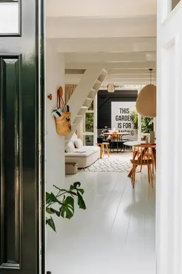 a living room with a staircase and a dining room at Sea and the City in Overveen