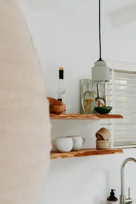 a kitchen with wooden shelves and a sink at Sea and the City in Overveen