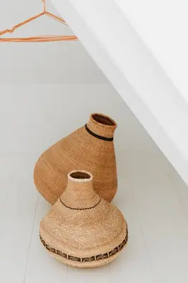 two vases are sitting on a white shelf at Sea and the City in Overveen