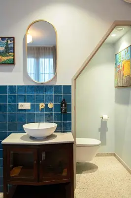 a bathroom with a sink and a toilet and a mirror at Boetiekhotel Het Gezellenhuis in Ouderkerk aan de Amstel