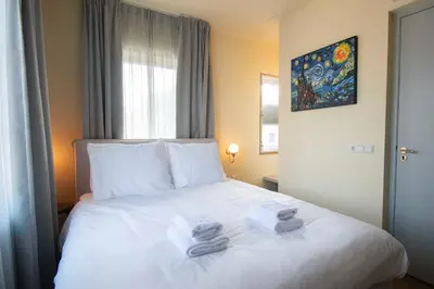 a hotel room with a bed with towels on it at Boetiekhotel Het Gezellenhuis in Ouderkerk aan de Amstel