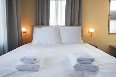 a bed with towels on top of it at Boetiekhotel Het Gezellenhuis in Ouderkerk aan de Amstel