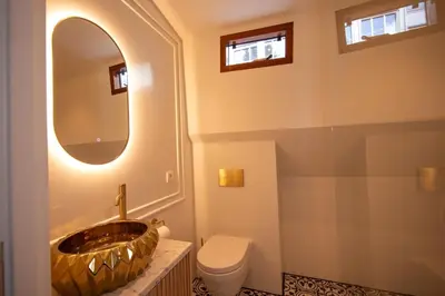 a bathroom with a sink and a toilet and a mirror at Canal Suite on Houseboat in Amsterdam