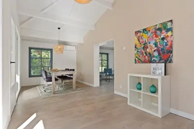 a living room with a table and a painting on the wall at Boerderijwoning 't Boetje in Heiloo