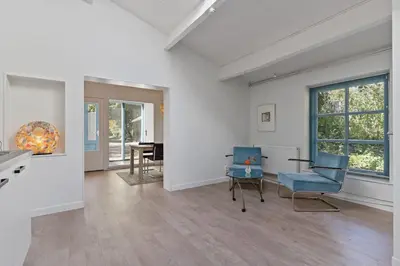 a living room with two blue chairs and a table at Boerderijwoning 't Boetje in Heiloo
