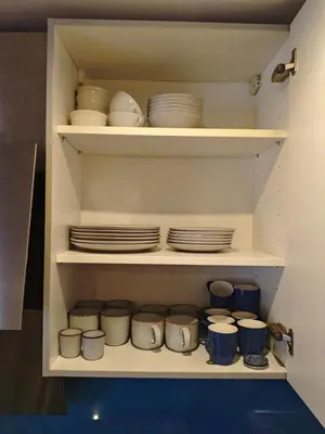 a cabinet filled with plates and bowls and dishes at The perfect spot in Akersloot