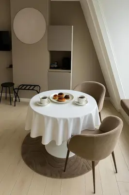 a white table with two cups and cookies on it at Manor Suite Amsterdam in Amsterdam