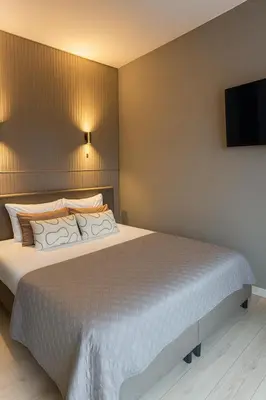 a bedroom with a bed and a flat screen tv at Manor Suite Amsterdam in Amsterdam