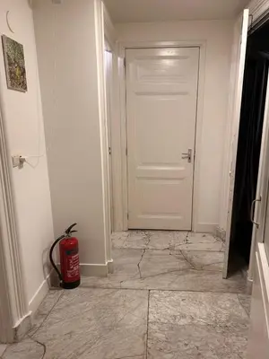 a room with a white door and a fire hydrant at Luxury Leidseplein with Private Patio in Amsterdam