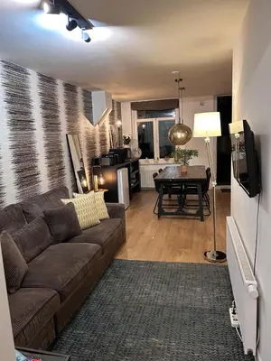 a living room with a couch and a table at Luxury Leidseplein with Private Patio in Amsterdam