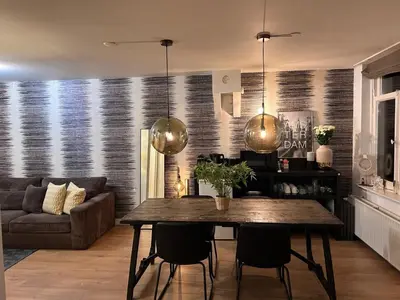 a living room with a table and a couch at Luxury Leidseplein with Private Patio in Amsterdam