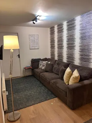 a brown couch in a living room with a window at Luxury Leidseplein with Private Patio in Amsterdam