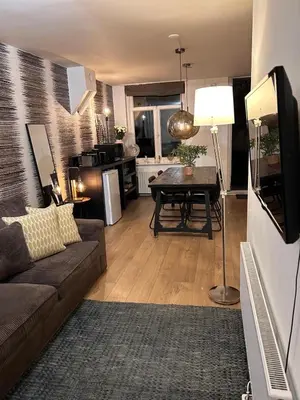 a living room with a couch and a table at Luxury Leidseplein with Private Patio in Amsterdam