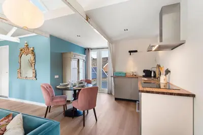 a kitchen and living room with a table and chairs at Abcoude city center in Abcoude