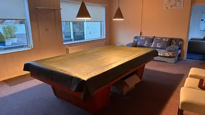a large bed in a room with a couch at Zaanvilla in Wormerveer