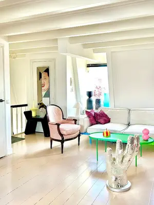 a living room with a couch and a table at Top floor apartment at Westerpark and Jordaan in Amsterdam