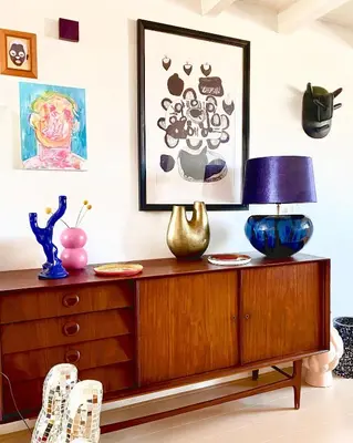 a wooden dresser with a lamp on top of it at Top floor apartment at Westerpark and Jordaan in Amsterdam