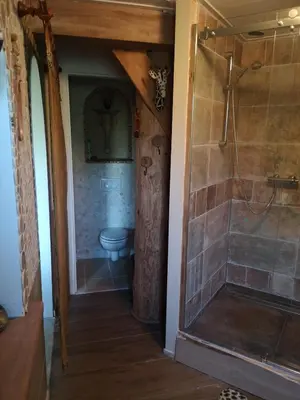 a bathroom with a toilet and a walk in shower at South African lodge in Westbeemster