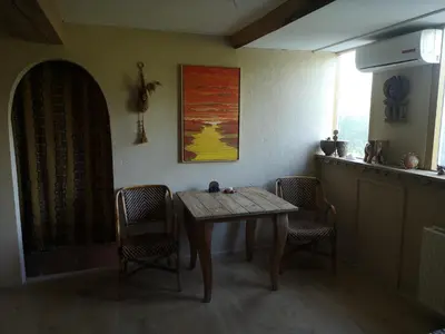 a dining room with a table and two chairs at South African lodge in Westbeemster