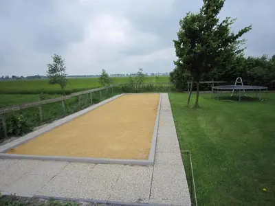 a picnic table and a bench in a field at Holiday Home in Noordbeemster with Bubble Bath in Noordbeemster