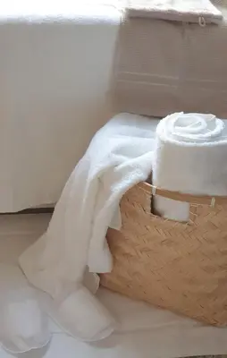 a basket filled with white towels on the floor at Little Magic Zandvoort in Zandvoort
