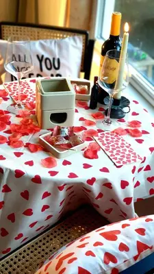 a table with a table cloth with a bottle of wine at Little Magic Zandvoort in Zandvoort