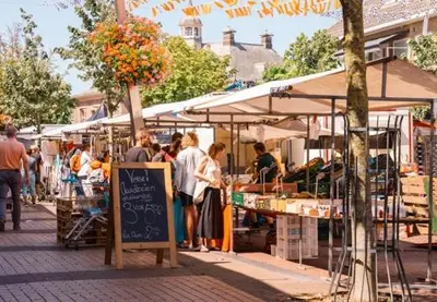 a group of people standing at an outdoor market at Little Magic Zandvoort in Zandvoort
