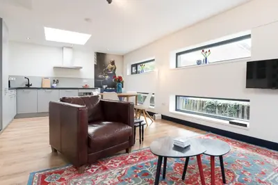 a living room with a couch and a table at Pakhuis Achter - Rustig gelegen vlakbij Amsterdam & Zaanse Schans in Wormerveer