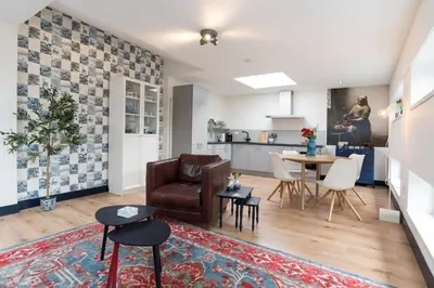 a living room with a couch and a table at Pakhuis Achter - Rustig gelegen vlakbij Amsterdam & Zaanse Schans in Wormerveer