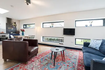 a living room with a couch and a table at Pakhuis Achter - Rustig gelegen vlakbij Amsterdam & Zaanse Schans in Wormerveer