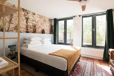 a bedroom with a bed and a brick wall at Herenstraat Residence in Amsterdam