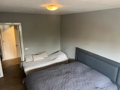 a bedroom with two beds in the corner at Provence Driehuis Apartment in Driehuis