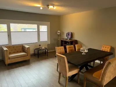 a dining room with a table and chairs at Provence Driehuis Apartment in Driehuis