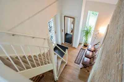 a staircase in a living room with a stair case at The Green Oasis charming family villa with garden and private parking in Zandvoort