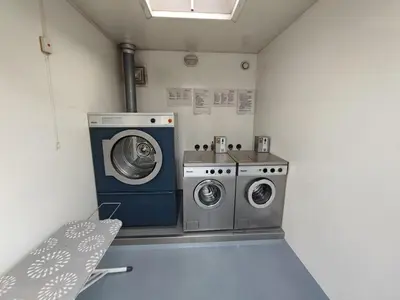 a laundry room with two washing machines in it at Floating holiday home close to AMS