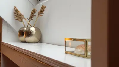 a shelf with a vase with flowers in it at Loft 55 Bergen-Schoorl Luxury Appartement 165m2 in Schoorl