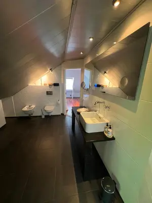 a bathroom with a sink and two toilets in it at Loft 55 Bergen-Schoorl Luxury Appartement 165m2 in Schoorl