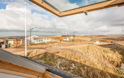 a view of a street from a window in a house at Light-flooded villa in Bergen aan Zee