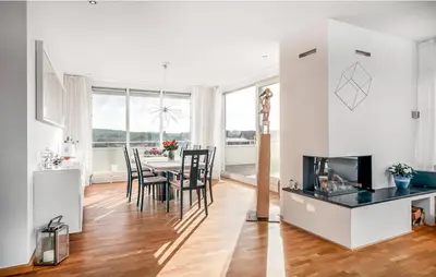 a kitchen and dining room with a table and chairs at Light-flooded villa in Bergen aan Zee