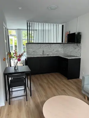 a living room with a table and a couch at Studio Fnidsen in Alkmaar